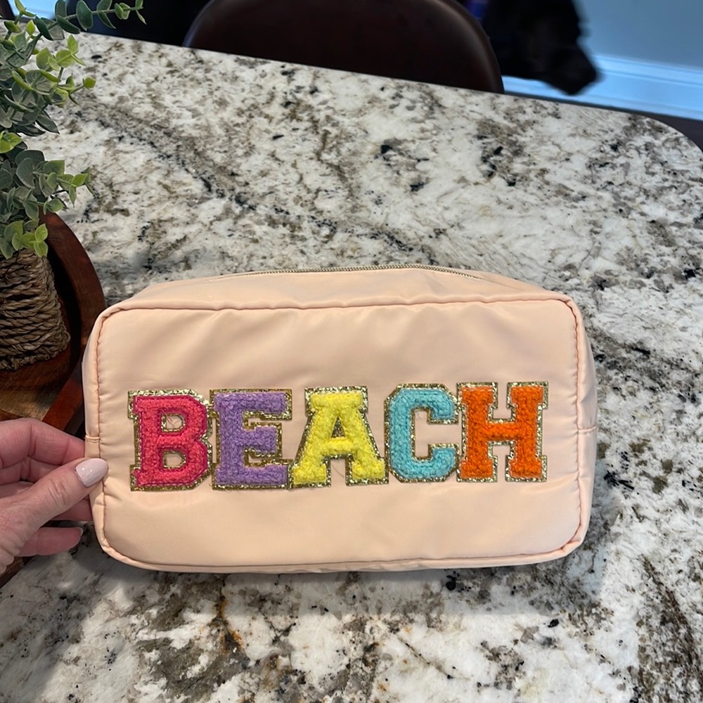 “beach” travel pouch. Super roomy and super cute!